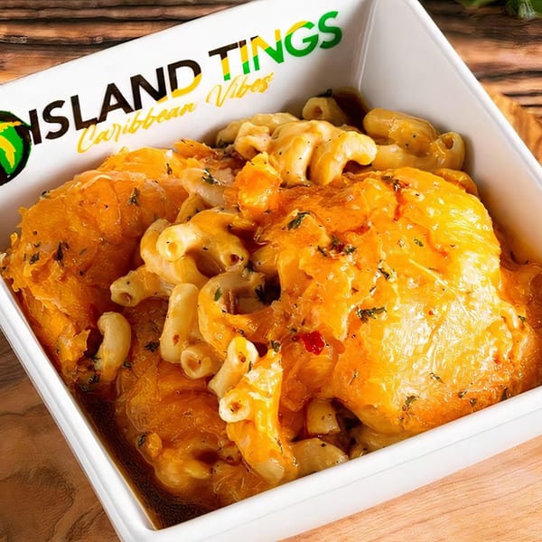 Island Tings' Jamaican mac and cheese with orange cheese, herbs, and red pepper flakes.